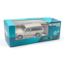 Load image into Gallery viewer, BM Creations Junior 1:64 Mitsubishi Pajero Mk1 w/ blk top Matte Ivory RHD
